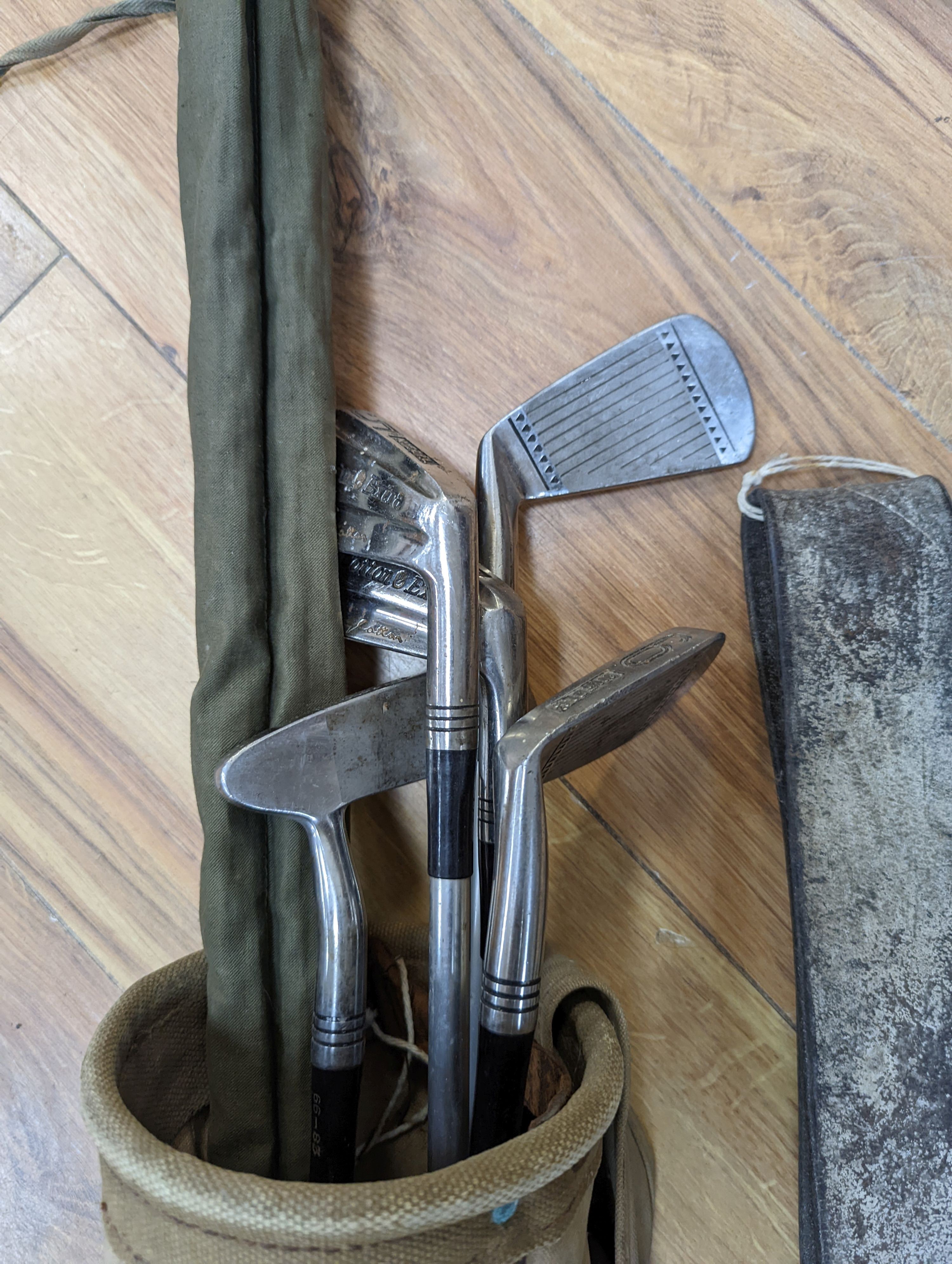 A split cane fishing rod, quantity of golf clubs, cows bell